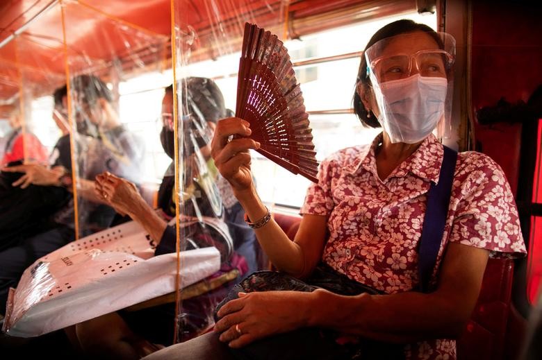 Jeepney passengers seated in between plastic barriers, wear face masks and face shields mandatory in public transportation, in Quezon City, Metro Manila, Philippines. REUTERS/Eloisa Lopez